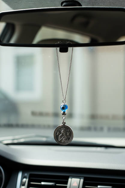 Car dashboard with a hanging pendant and blue bead